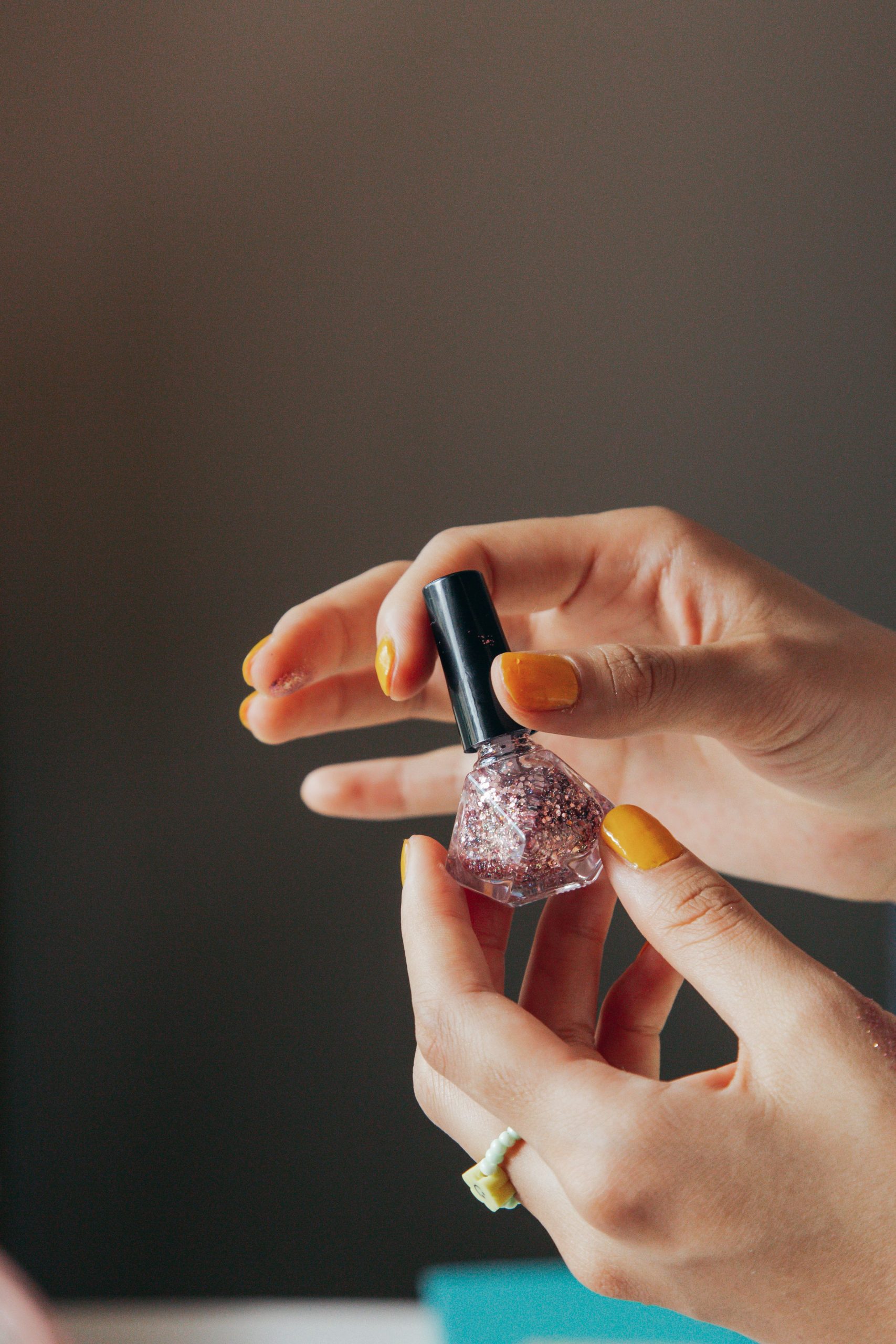 Woman looking at a glittery nail varnish